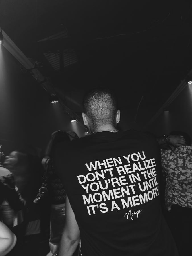 The back of a shirt reading: when you don’t realize you’re in the moment until it’s a memory